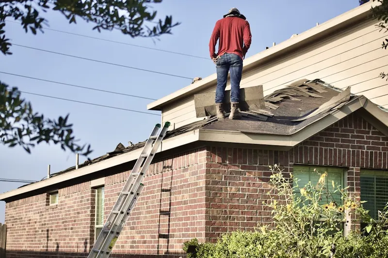 Professional roofer working on a residential roof in Estrella Park